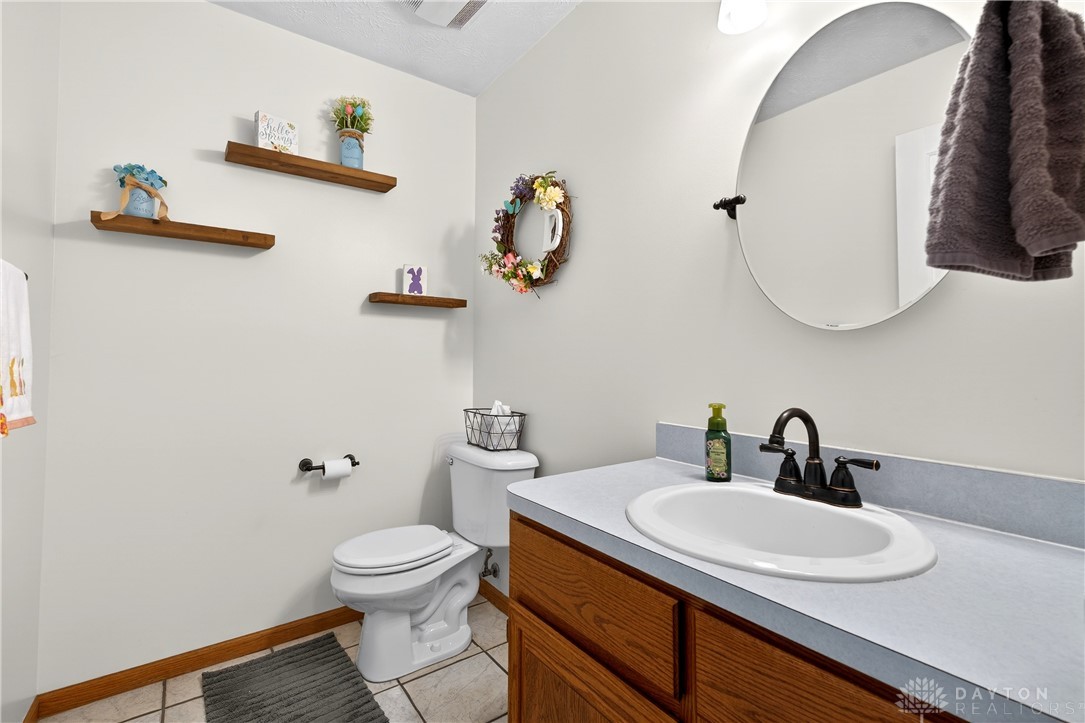 6560 Snyder Road Fletcher, OH 45326 - Photo 25 of 71 This clean and inviting bathroom features classic flooring and a simple yet functional vanity space.