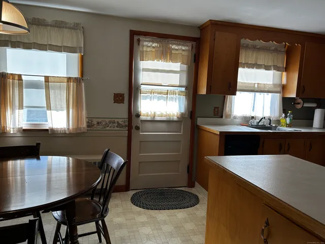 a kitchen with a table chairs and microwave