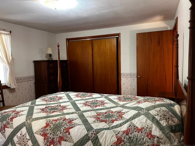 a bedroom with a bed and a mirror