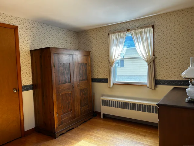 a view of room with window and hardwood floor