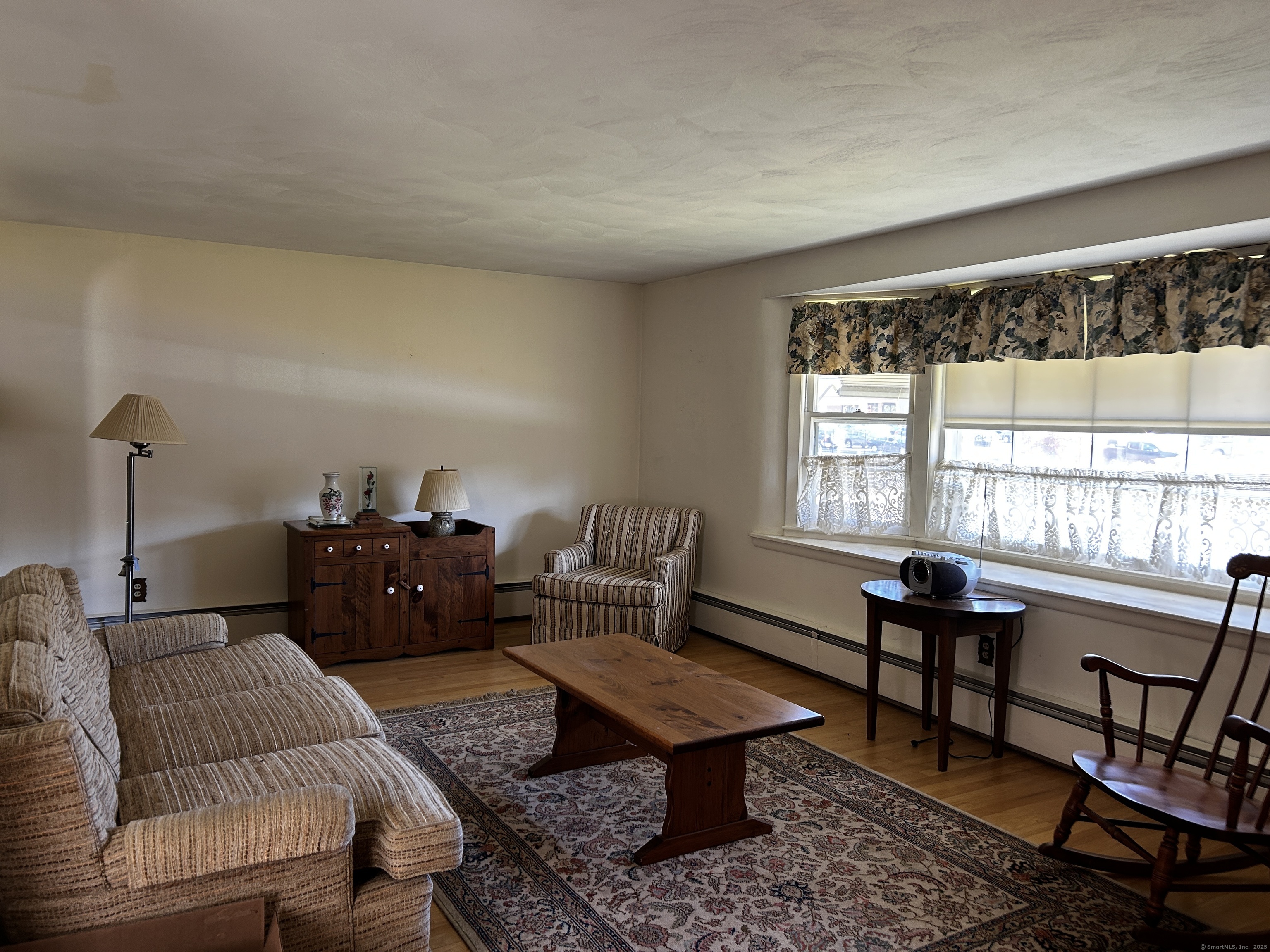 69 Wauregan Road Killingly, CT 06239 - Photo 4 of 23 a living room with furniture a rug and a window