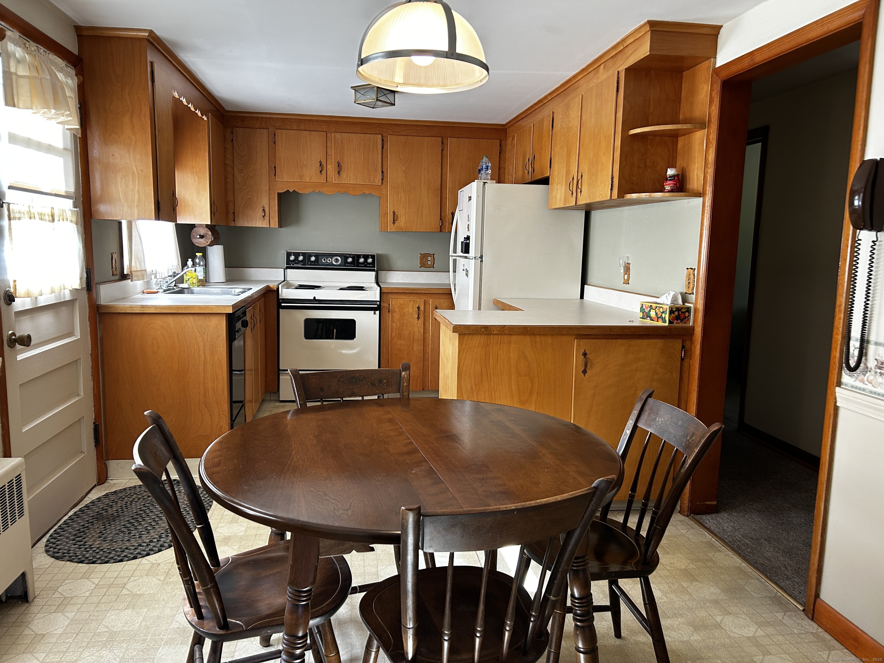 69 Wauregan Road Killingly, CT 06239 - Photo 8 of 23 a kitchen with a table chairs a sink dishwasher window and cabinets