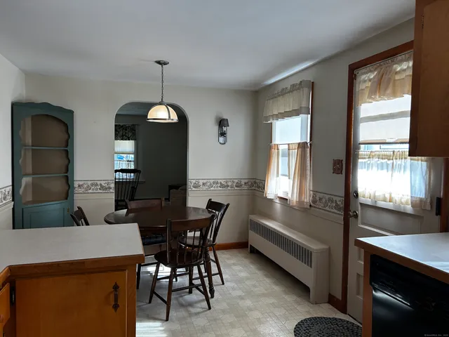 a dining room with furniture and window