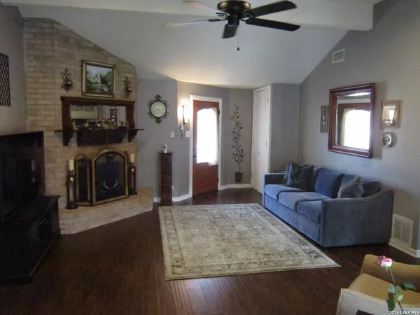 a living room with furniture and a fireplace
