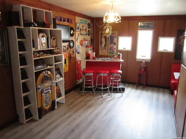 a view of a room with furniture and wooden floor