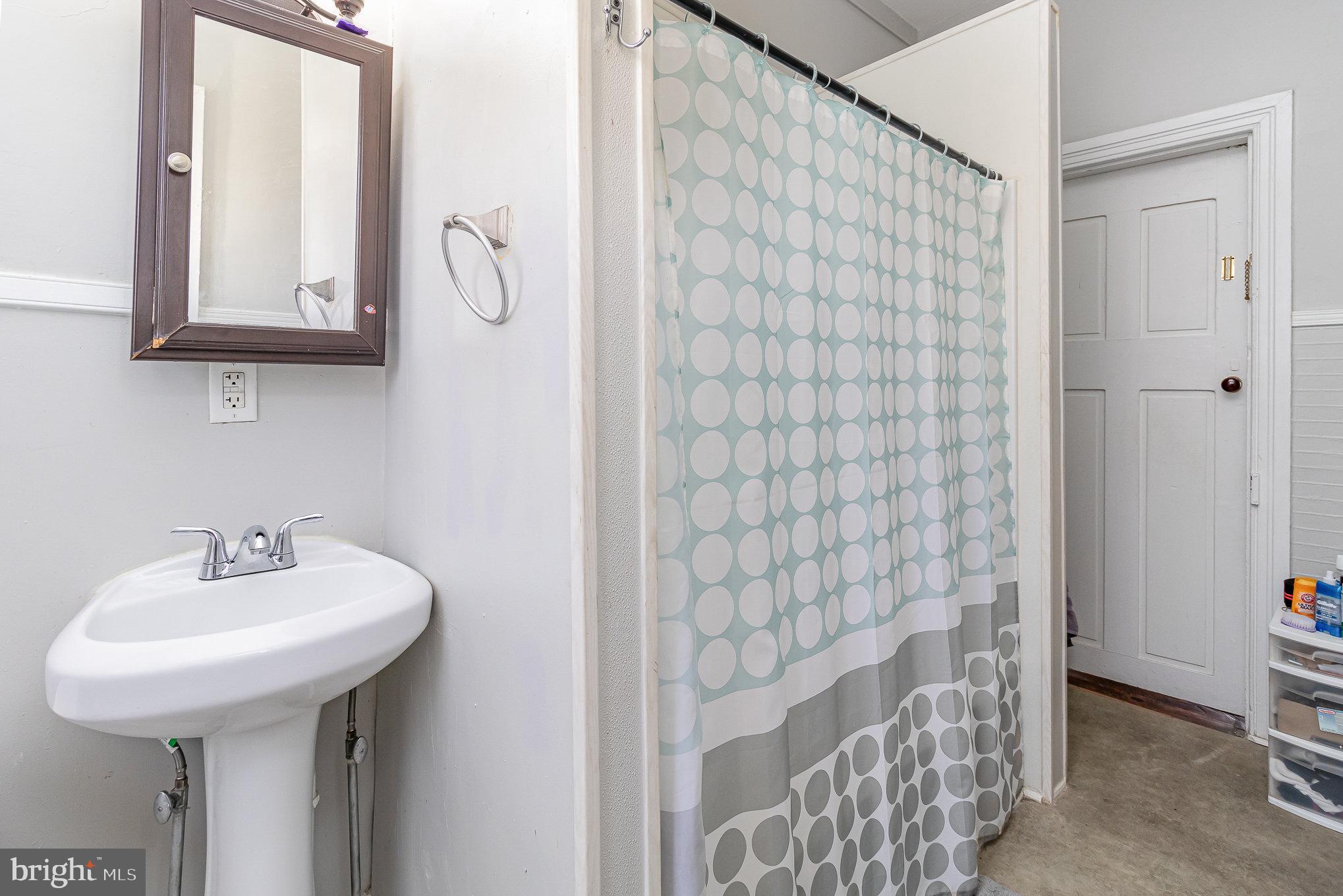 151 South Pershing Avenue York, PA 17401 - Photo 11 of 21 a bathroom with a sink a mirror and shower