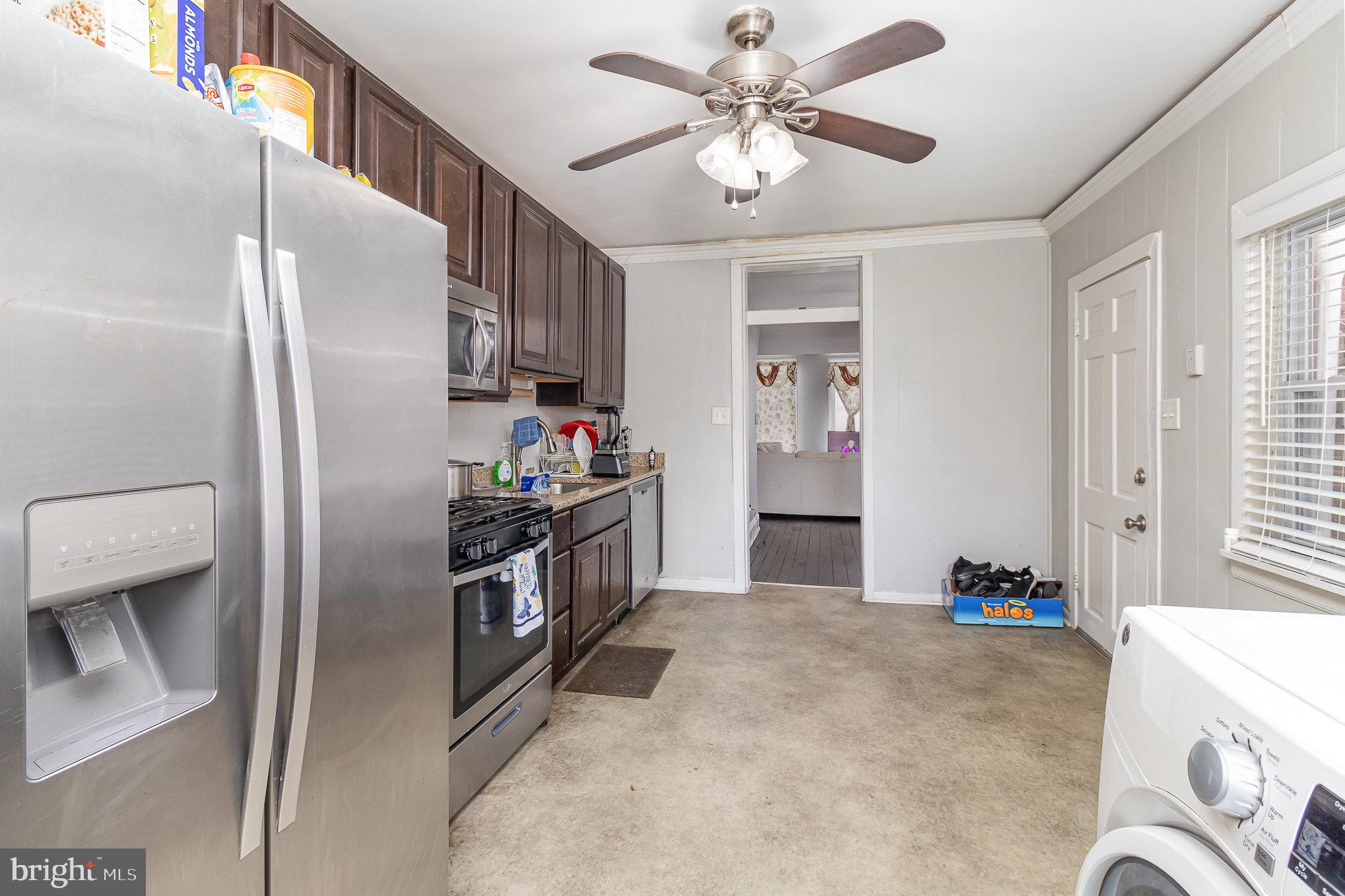 151 South Pershing Avenue York, PA 17401 - Photo 8 of 21 a kitchen with stainless steel appliances kitchen island granite countertop a refrigerator a stove a sink and a refrigerator