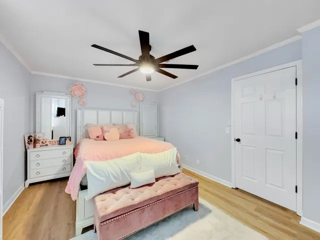 a bedroom with a bed and a ceiling fan