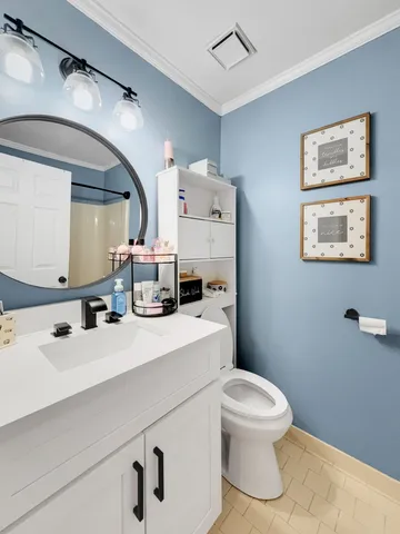 a bathroom with a sink a toilet and a mirror