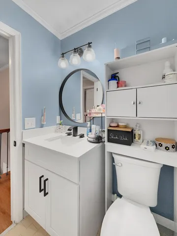 a bathroom with a toilet sink and mirror