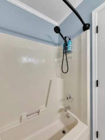 a bathroom with a bath tub with a shower