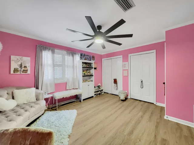 a bedroom with furniture and a ceiling fan