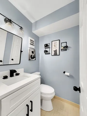 a bathroom with a toilet a sink and mirror