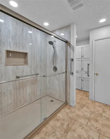 a bathroom with a shower and a sink