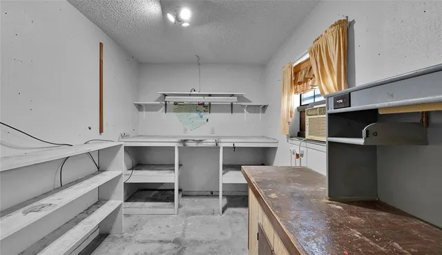 a kitchen with kitchen island a sink stainless steel appliances and cabinets