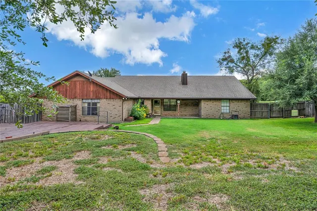 a front view of house with yard and green space