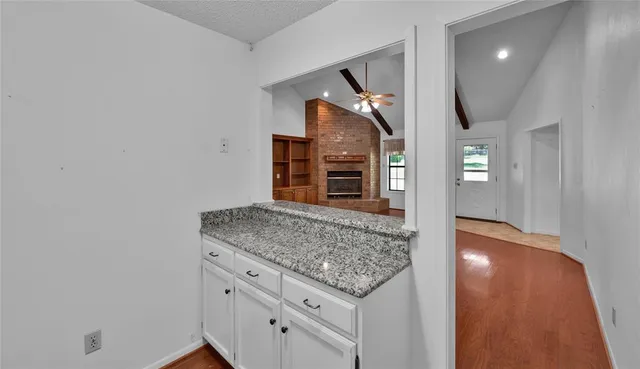 a view of a kitchen cabinets and wooden floor