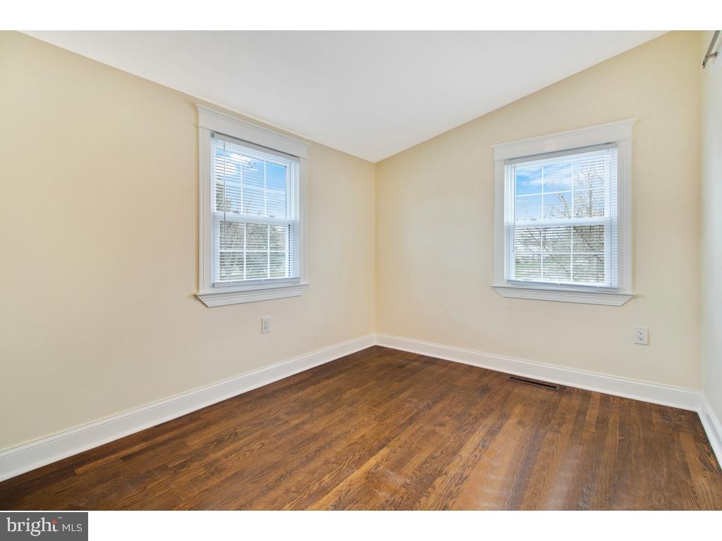 1101 Dorchester Road Newark, DE 19713 - Photo 8 of 19 a view of an empty room with wooden floor and a window