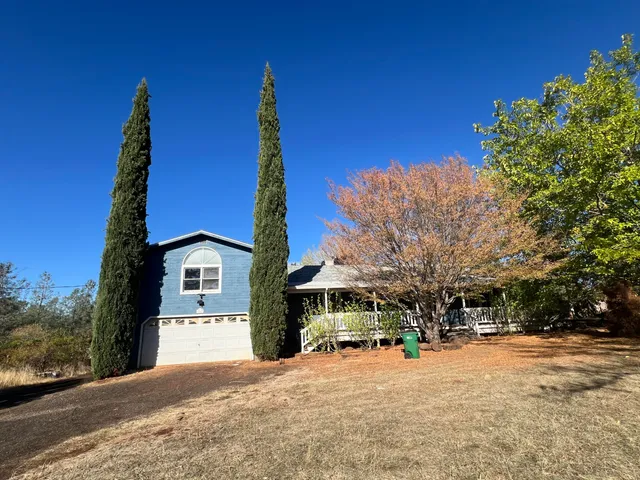 a front view of a building with trees