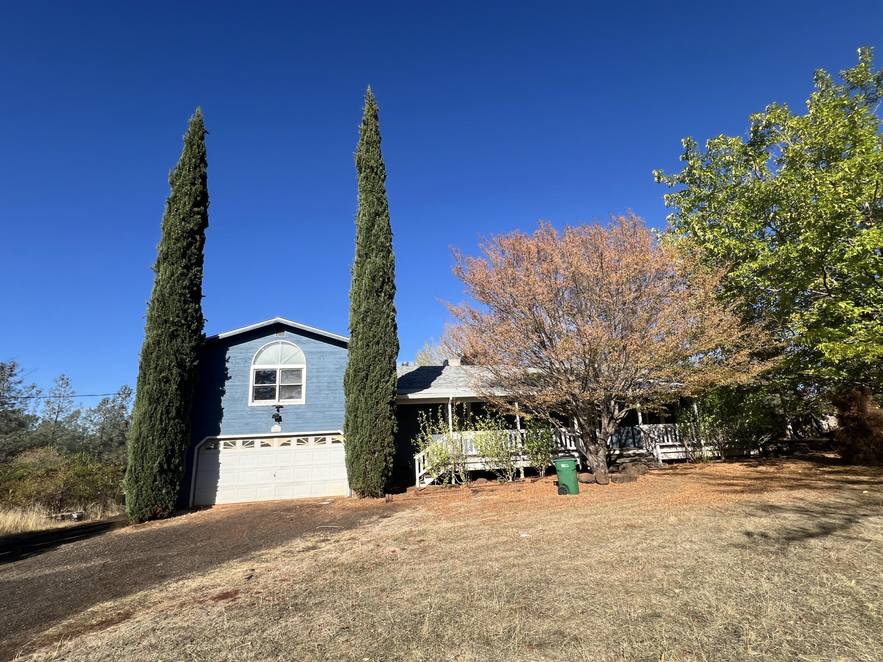 a front view of a building with trees
