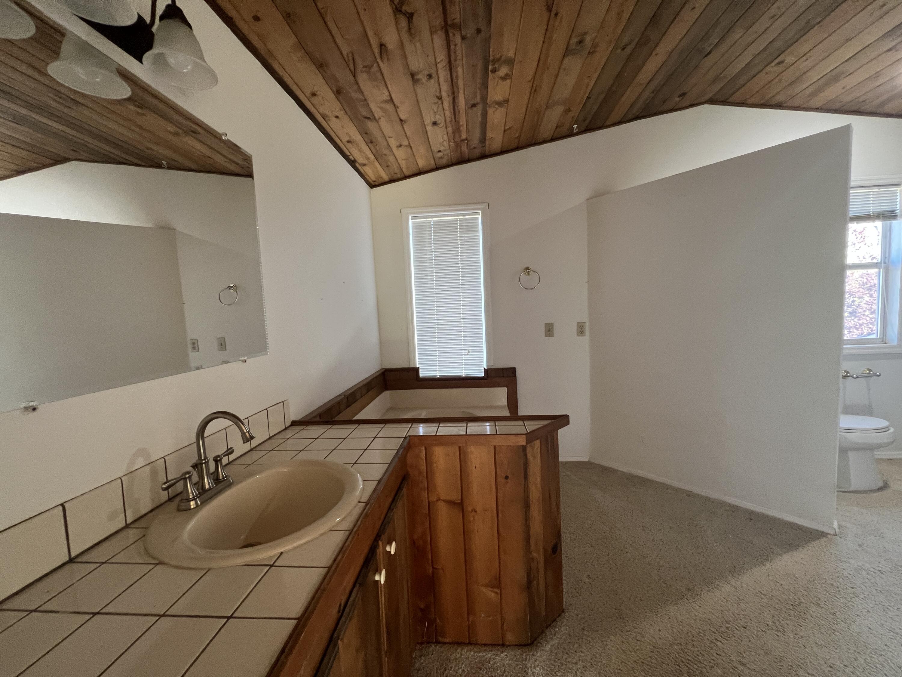 7582 Black Butte Road Shingletown, CA 96088 - Photo 14 of 25 a bathroom with a granite countertop sink and a mirror