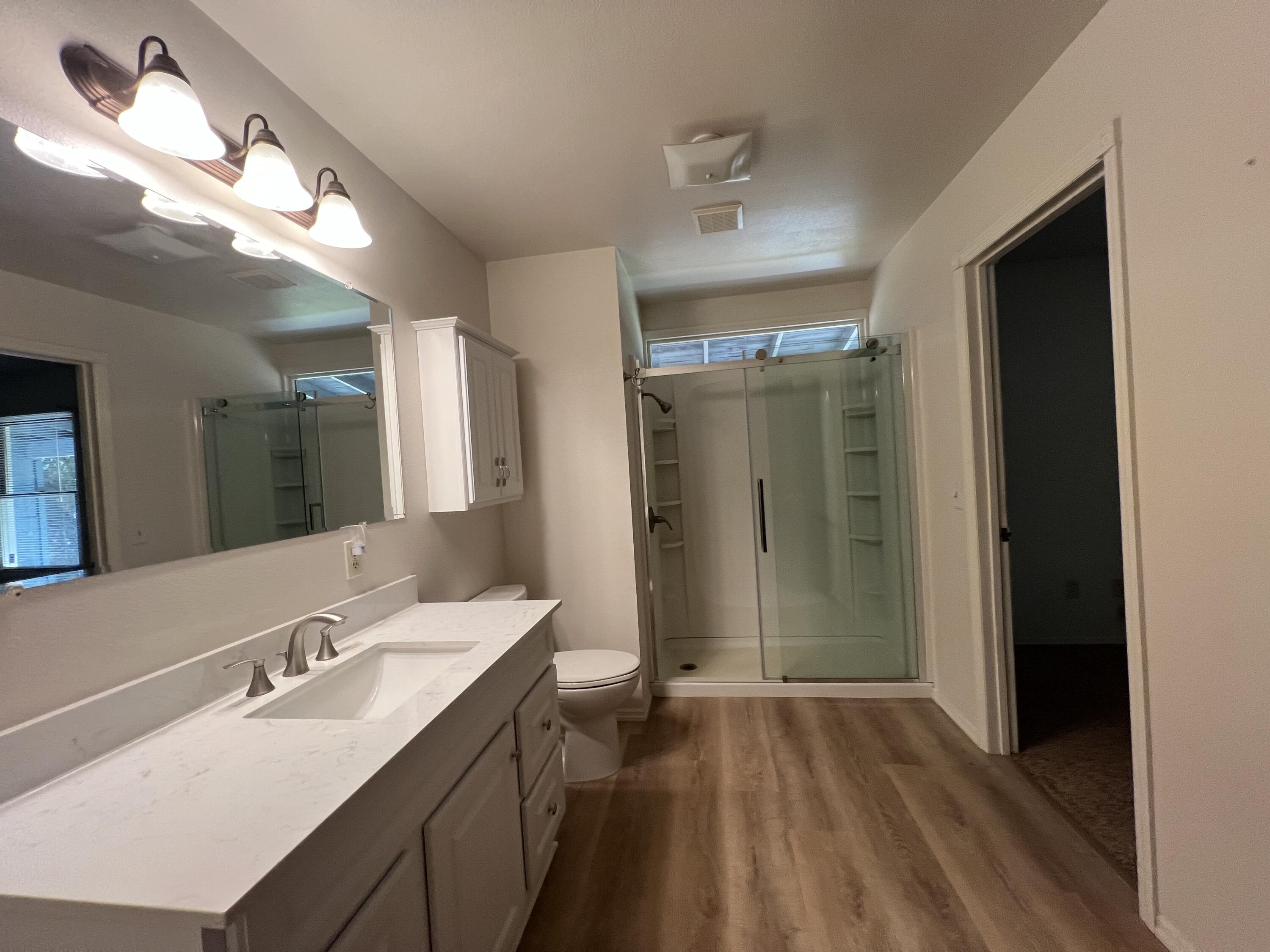 7582 Black Butte Road Shingletown, CA 96088 - Photo 17 of 25 a bathroom with a sink vanity granite tub and a mirror