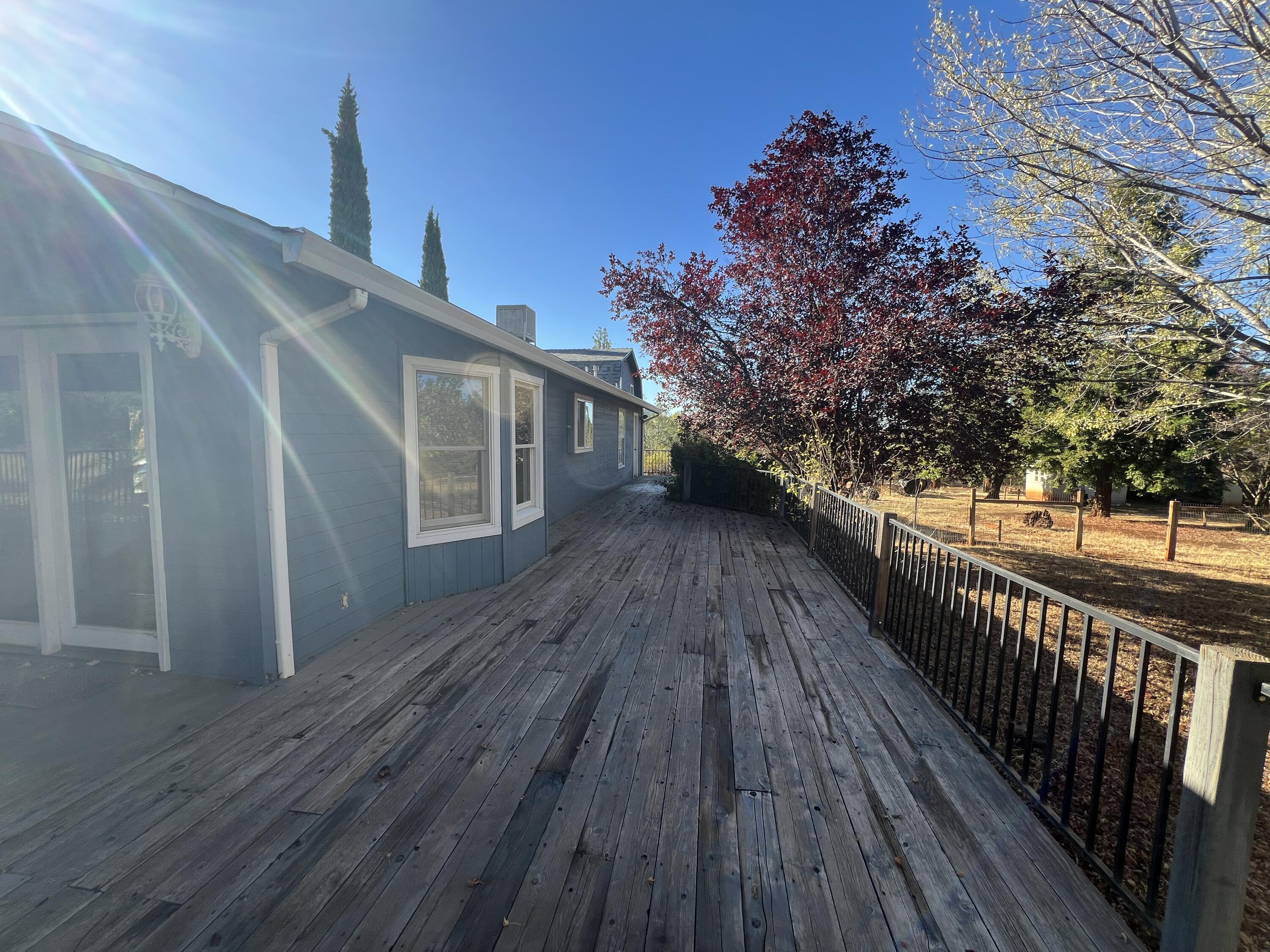 7582 Black Butte Road Shingletown, CA 96088 - Photo 24 of 25 a view of a balcony with wooden floor and fence