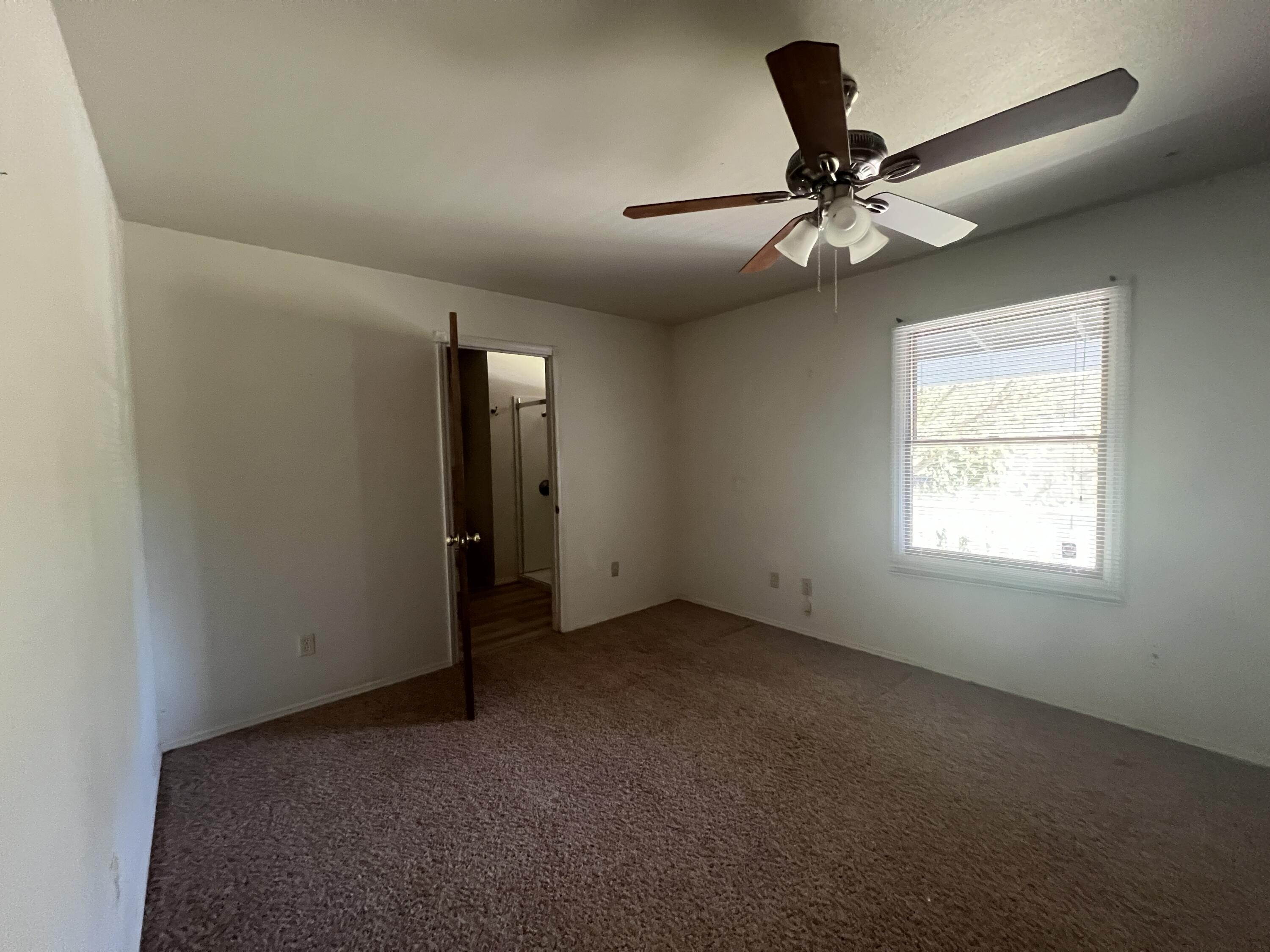 7582 Black Butte Road Shingletown, CA 96088 - Photo 8 of 25 an empty room with windows and fan