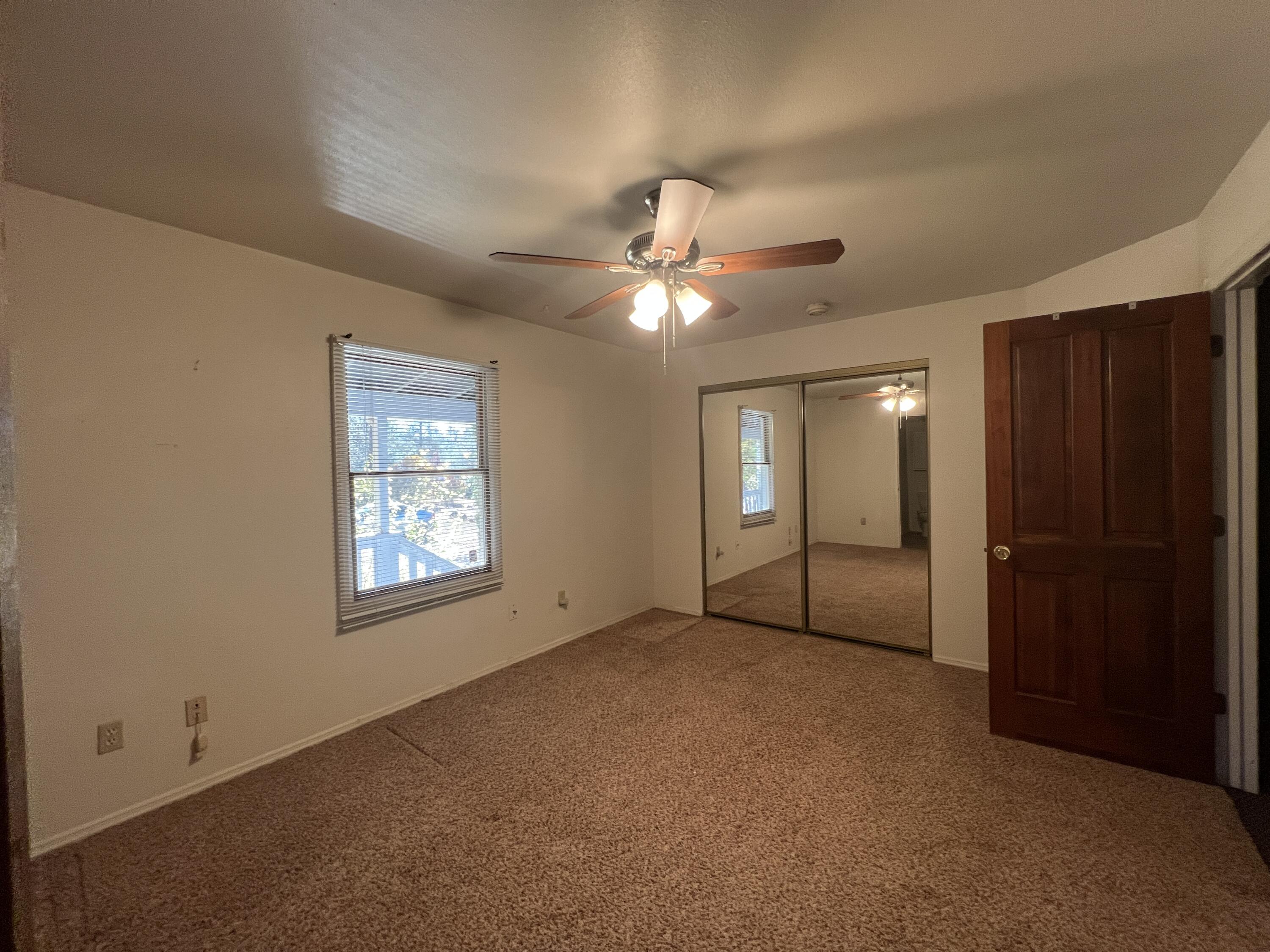 7582 Black Butte Road Shingletown, CA 96088 - Photo 10 of 25 an empty room with windows and fan