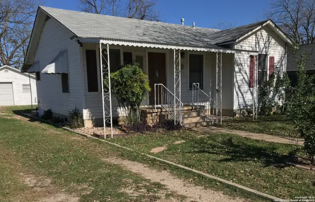 a front view of house with a garden