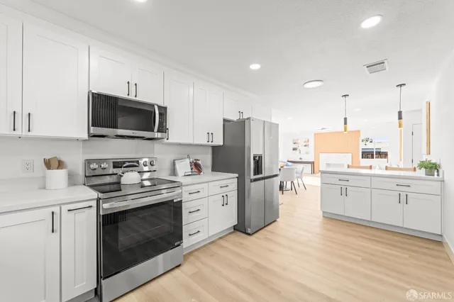 a kitchen with a stove a sink and a microwave