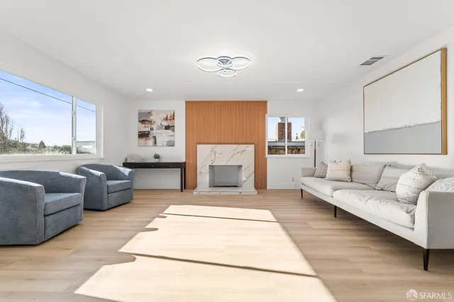 a living room with furniture and a fireplace