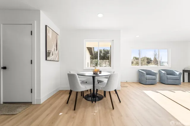 a dining room with furniture and wooden floor