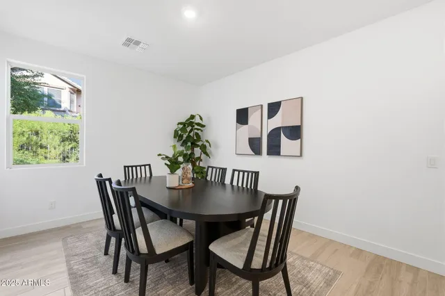 a view of a dining room with furniture and window