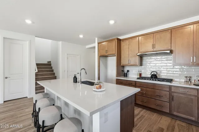 a kitchen with a sink cabinets and wooden floor