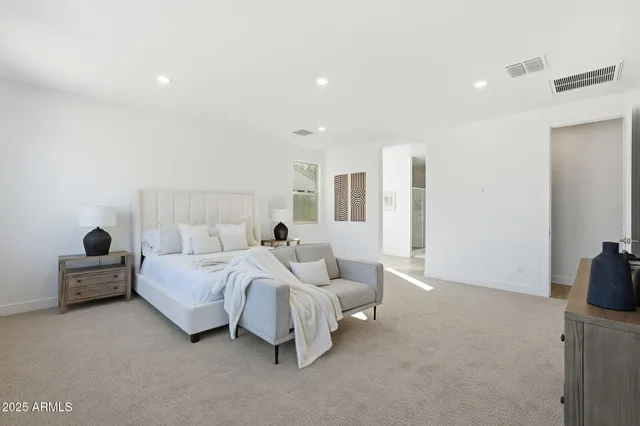 a spacious bedroom with a bed and window