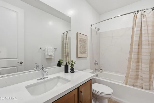 a bathroom with a sink toilet tub and shower