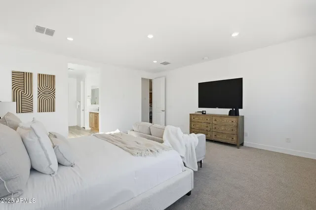 a bedroom with a bed and a flat screen tv