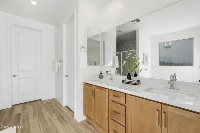 a bathroom with a double vanity sink and mirror