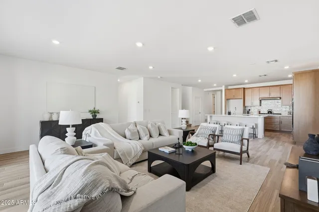 a living room with furniture wooden floor and a table