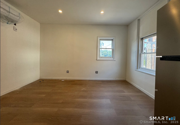 61 Field Street, Unit 106 Waterbury, CT 06702 - Photo 2 of 5 an empty room with windows