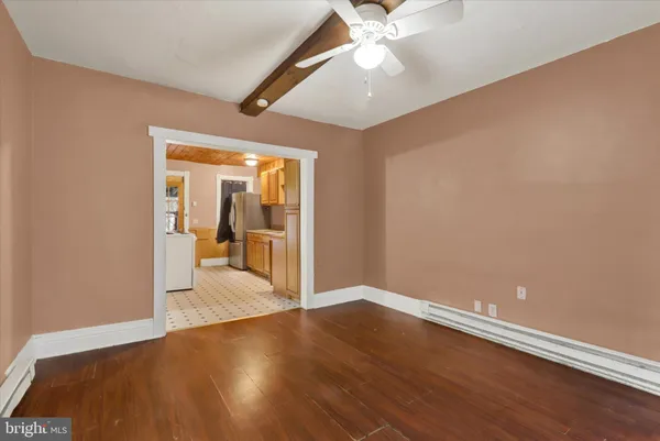 a view of an empty room with wooden floor