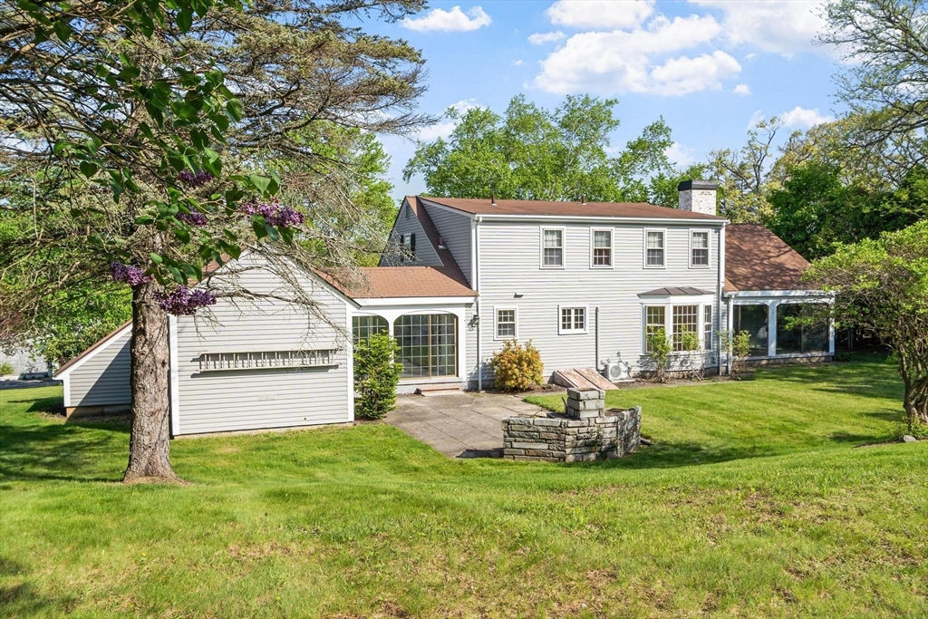 454 Wilson Street Clinton, MA 01510 - Photo 8 of 39 a front view of a house with a garden and trees
