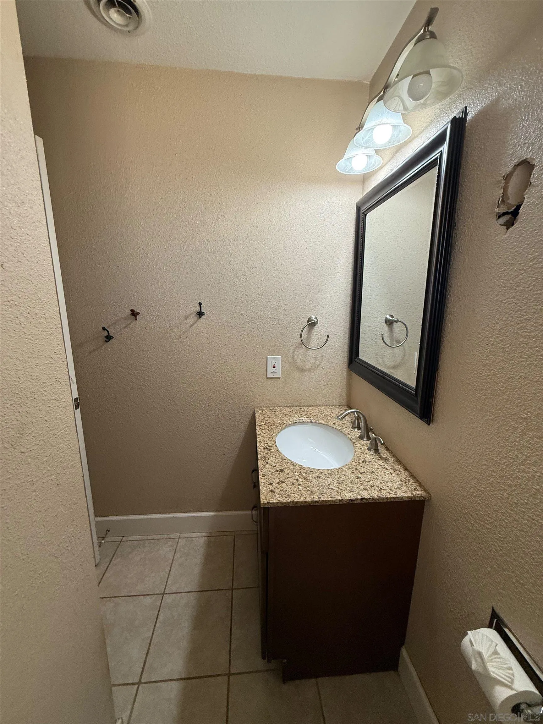 23273 Marsh Creek Road Brentwood, CA 94513 - Photo 6 of 8 a bathroom with a granite countertop sink and a mirror