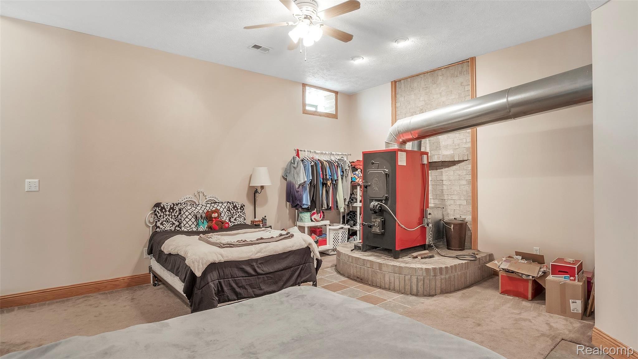 6063 Rivers Edge Drive Howell, MI 48855 - Photo 26 of 39 YES, more space in the finished basement. Wood furnace heated entire home easily, clean and ready to fire up, owners use the furnace now that natural gas is at the home. this area was usually a family room.