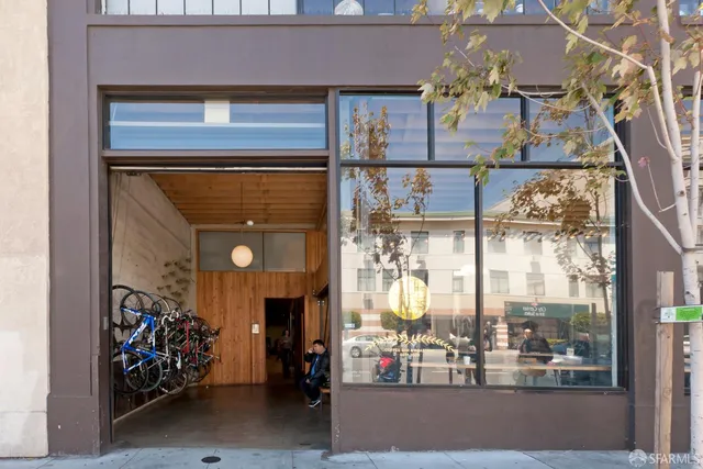 a variety of fruits and vegetables with building in the background