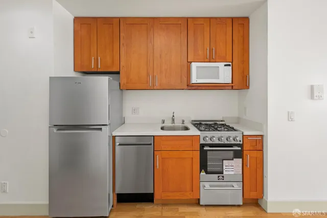 a kitchen with a stove and a refrigerator