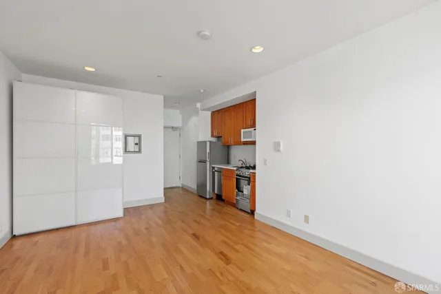a view of a kitchen with a sink and a refrigerator