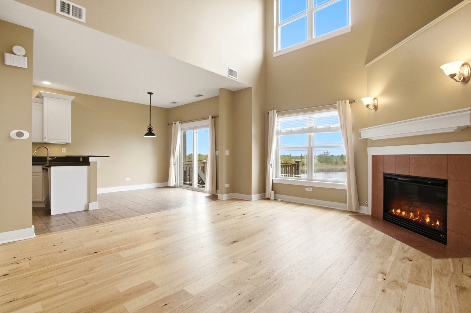 15749 West Crobally Way Manhattan, IL 60442 - Photo 2 of 24 a view of an empty room with a fireplace and a window