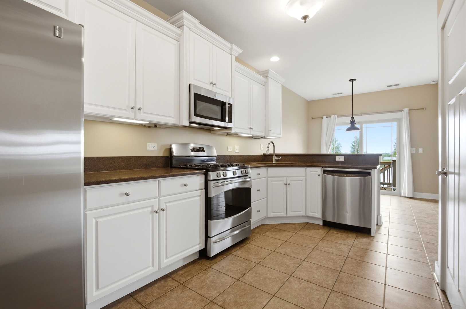 15749 West Crobally Way Manhattan, IL 60442 - Photo 8 of 24 a kitchen with stainless steel appliances granite countertop white cabinets a sink a stove a microwave and a refrigerator